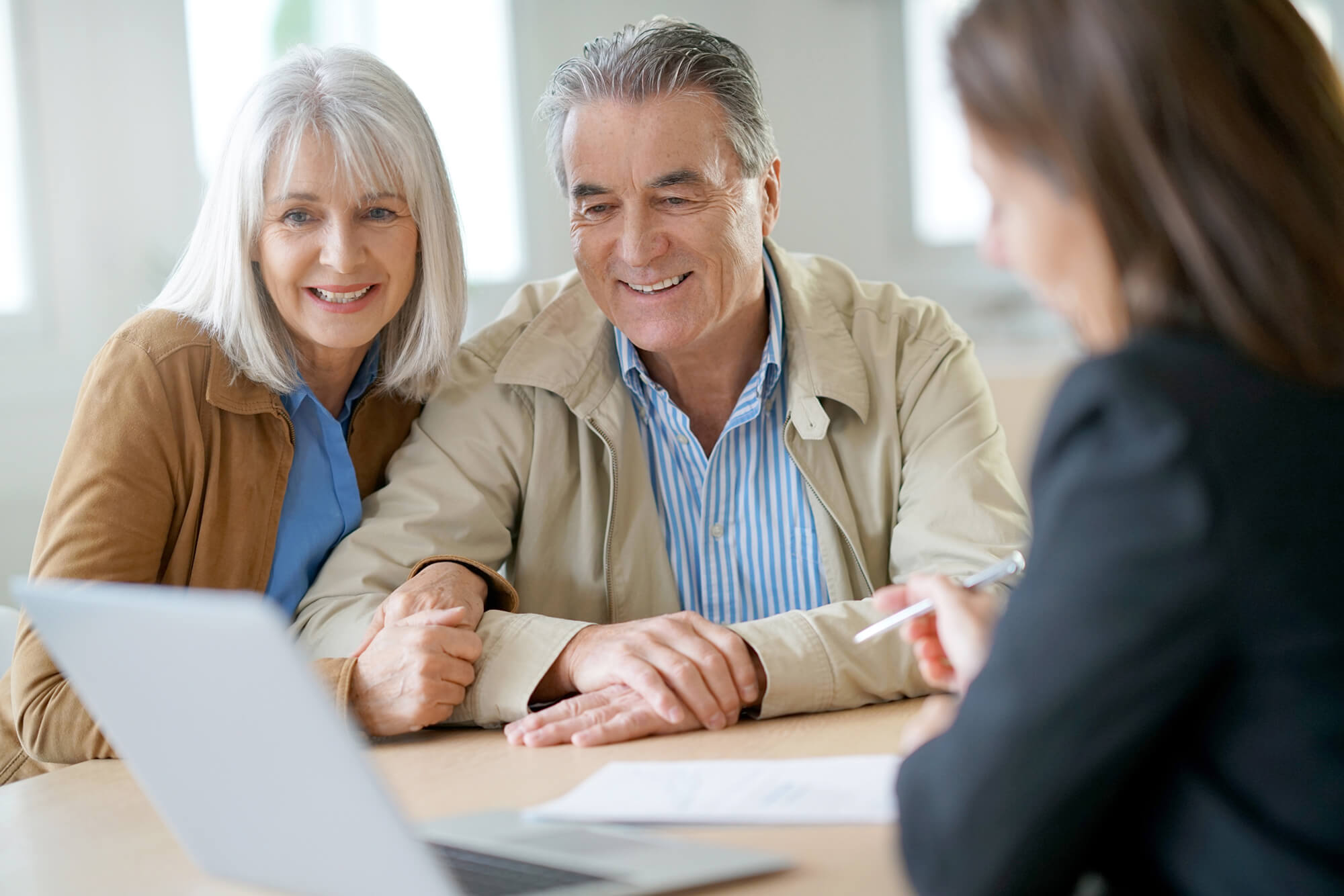 An image of two people meeting with their financial advisor